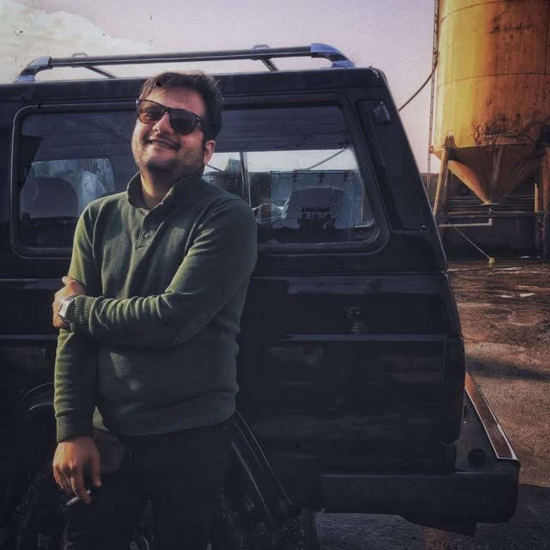 Habib Parvin standing beside a black vehicle